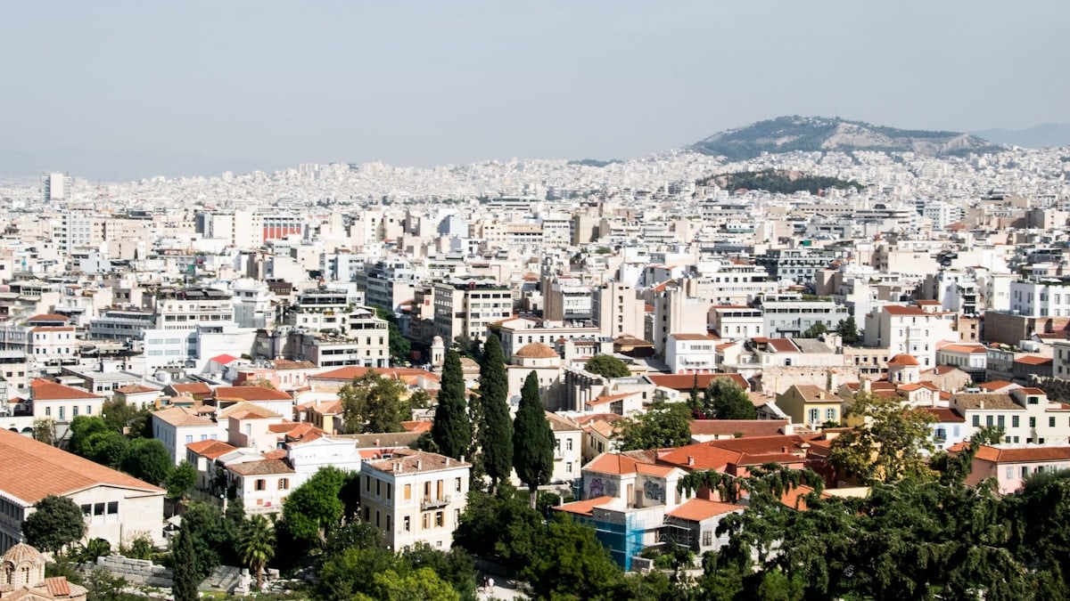 a view of a city with a hill in the background